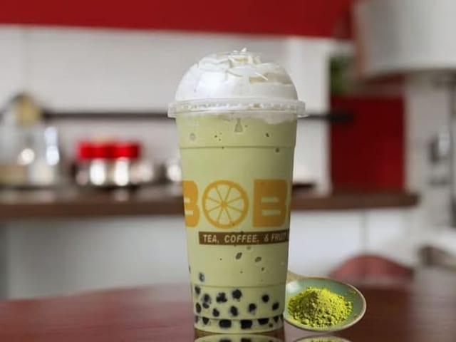Frozen Matcha Green Tea with Boba and Whipped Cream.