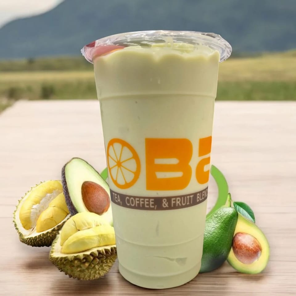 I HEART BOBA FM 529 avocado smoothie with fresh durian and avocado halves on a wooden table.
